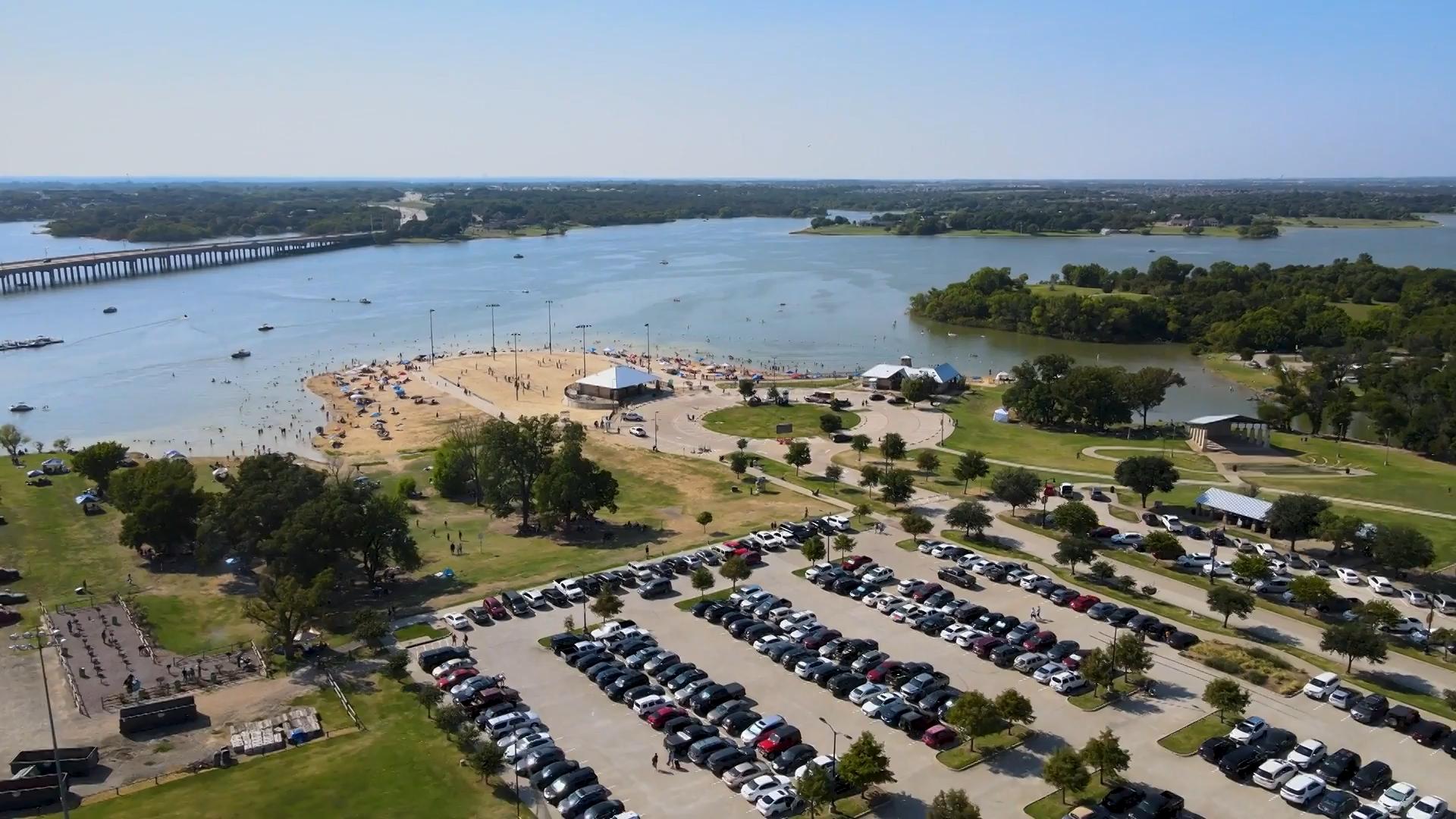 An aerial view of a parking lot and a bridge.